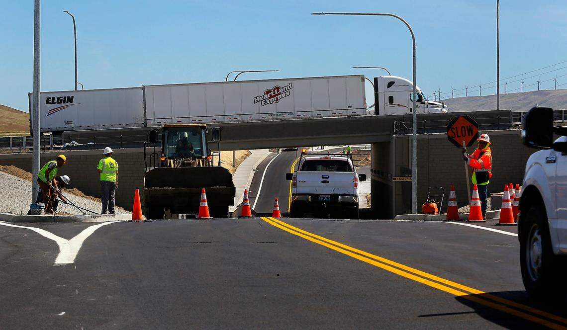 Traffic lines up in the construction zone on Ridgeline Drive to drive under Highway 395 in south Kennewick as crews put the finishing touches on the recently opened $22.5 million underpass interchange project. Employees with Scarsella Brothers Contractors moved of tons of dirt for the project, which started in April 2021.