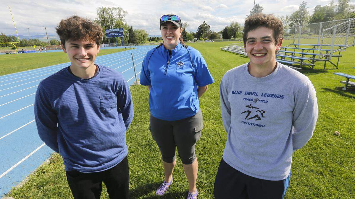Walla Walla High School athletic trainer Kelsey Dill, center, and junior Colby Turner, right, helped save Jacob Pribilsky's life after he collapsed at a recent track meet. More automated defibrillators, like the one used to save the 17-year-old, are needed at student athletic events, say officials.