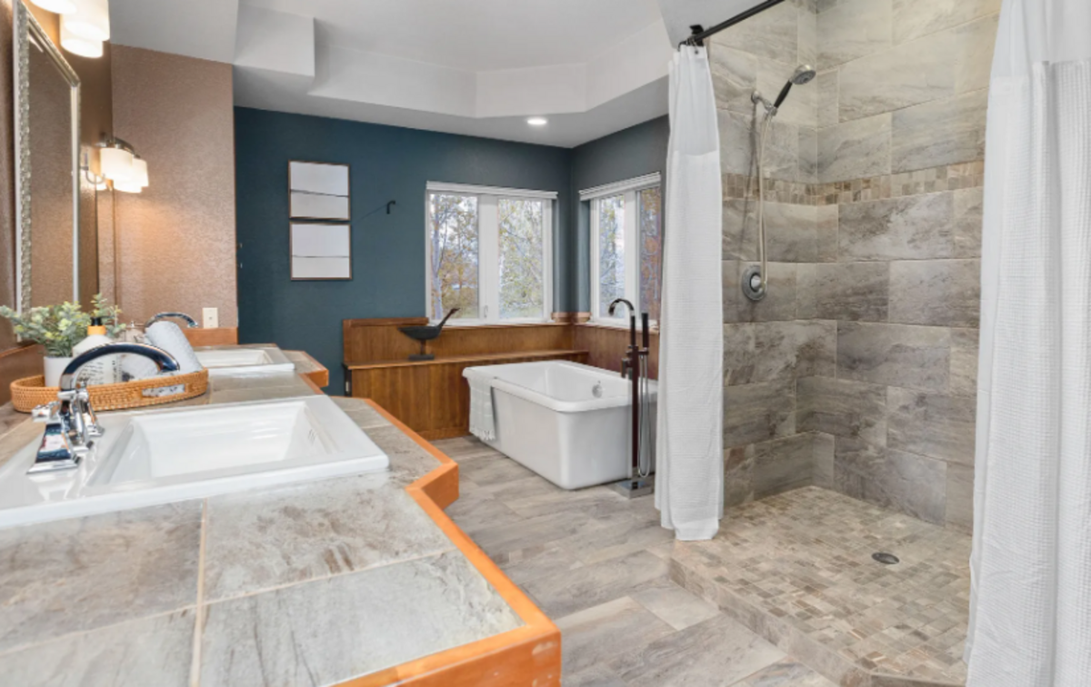 The custom built home is listed by Century 21 Tri-Cities boasts sweeping river views and a 1.7-acre lot.
