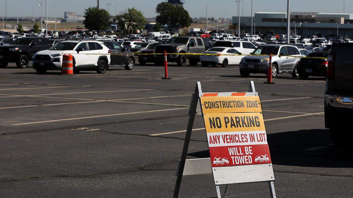 Signs and caution tape block off rows in the long term parking lot at the Tri-Cities Airport for planned repairs at the Pasco facility.