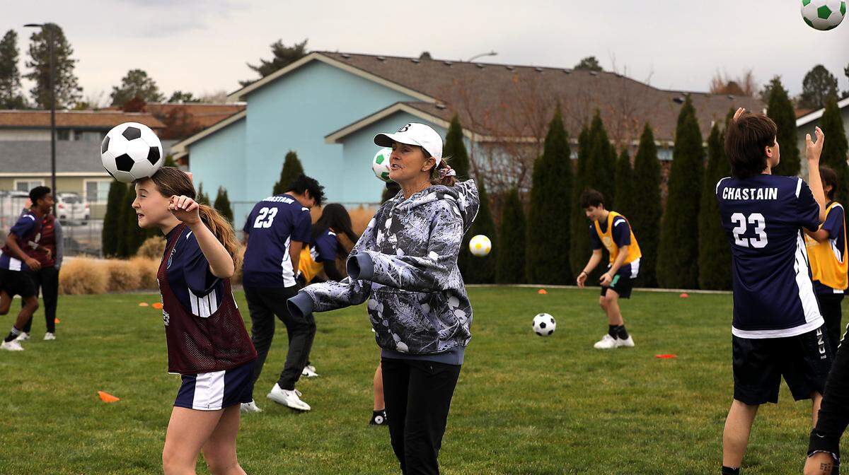 Brandi Chastain, two-time Olympic gold medalist and FIFA Women’s World Cup champion, watches a player make a header at a soccer skills clinic she conducted during her visit Friday at the Boys & Girls Club of Benton and Franklin Counties site in Kennewick. Chastain was in the Tri-Cities for the Boys & Girls Club’s annual fundraising event Dinner with Friends, which was held the Three Rivers Convention Center Friday evening. Several dozen local youth participated in the skills clinic.