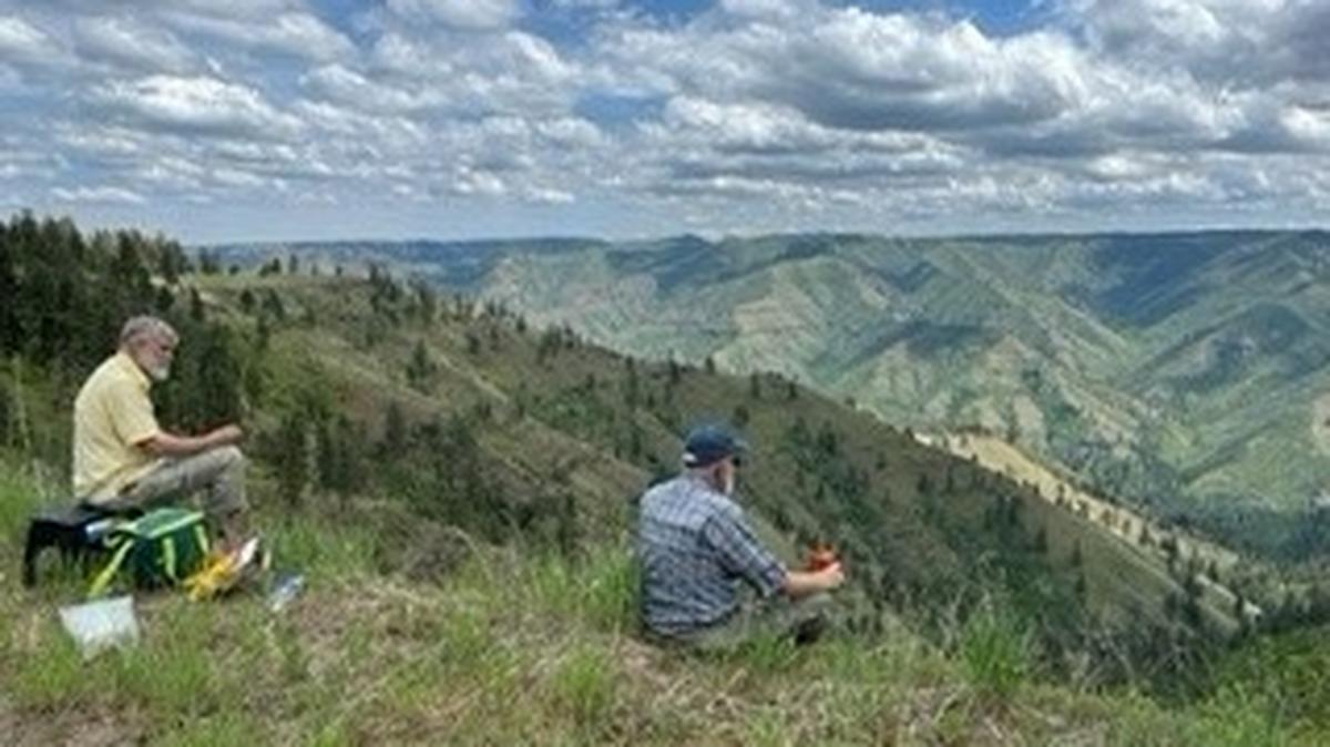 Ted Poston and Ken Gano ponder ancient lava flows while they eat lunch above the Tucannon River canyon.