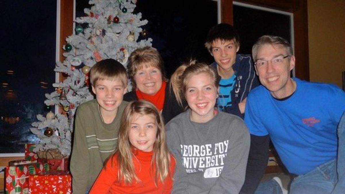 Gary and Jael Cox celebrate an unexpected Christmas gift with their children in 2010.