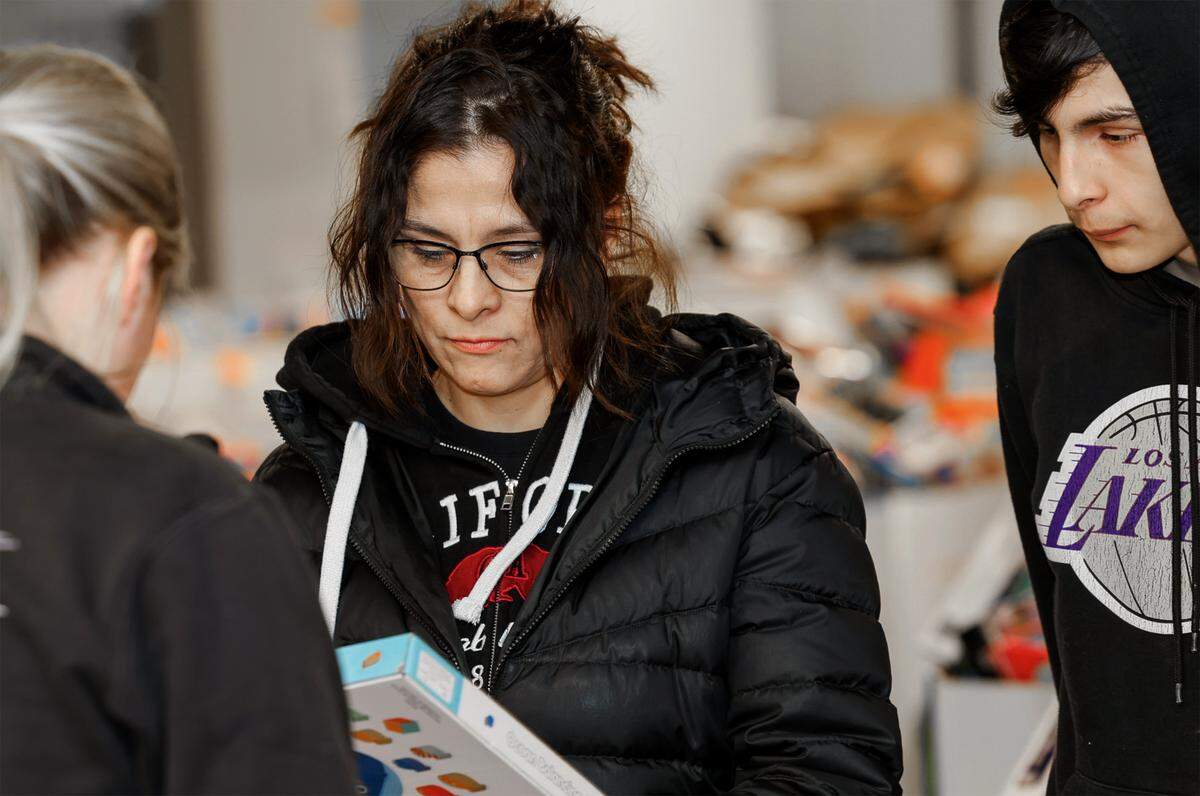 Erica Magana of Kennewick and her son, Gael, volunteer to help select toys for the families that will get them for Christmas through the Marine Corps Reserve Toys for Tots Santa’s Workshop.