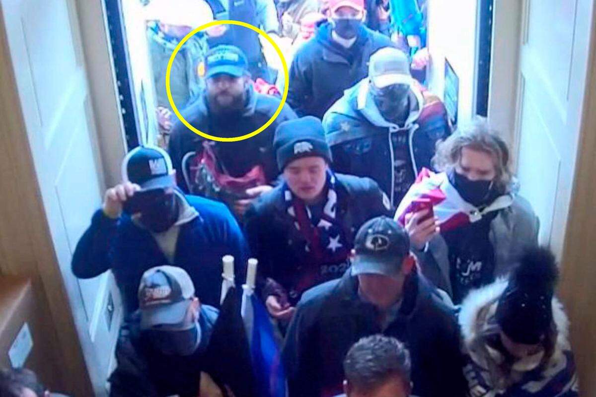In this image from U.S. Capitol Police security video, released and annotated by the Justice Department in the Statement of Facts supporting an arrest warrant, Taylor Taranto, circled in yellow, enters the U.S. Capitol through the Upper West Terrace door on Jan. 6, 2021, in Washington.  