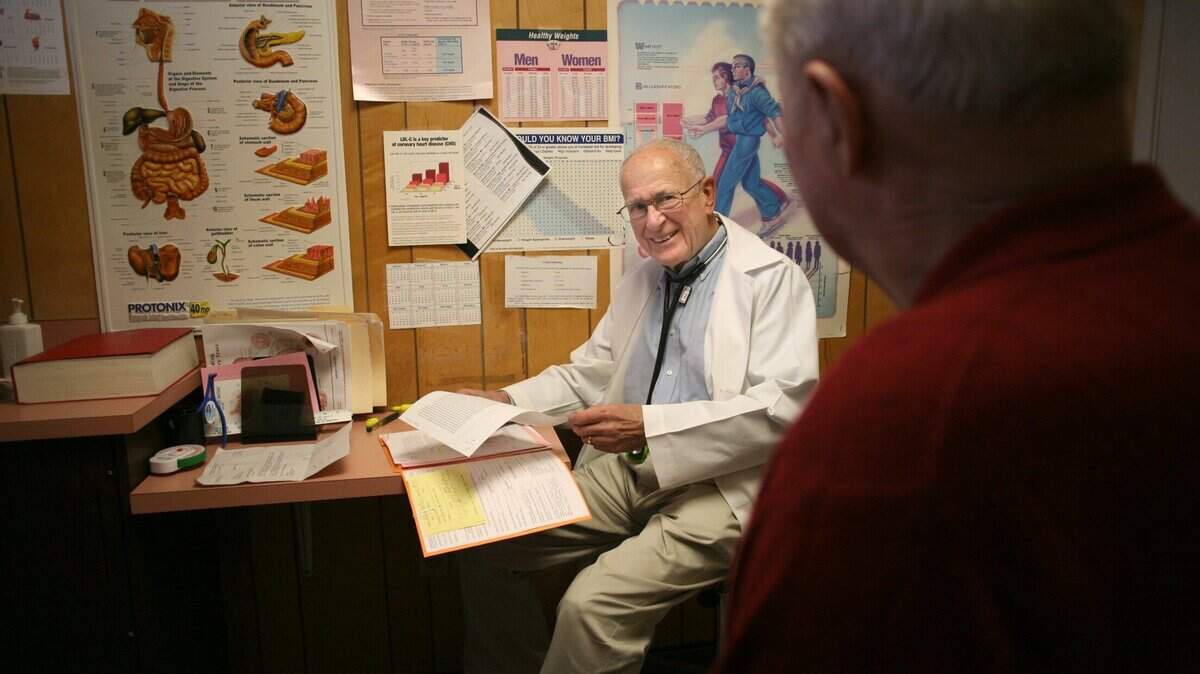 Dr. Rod Coler talks with a patient in 2006. He practiced medicine in the Tri-Cities for nearly half a century.