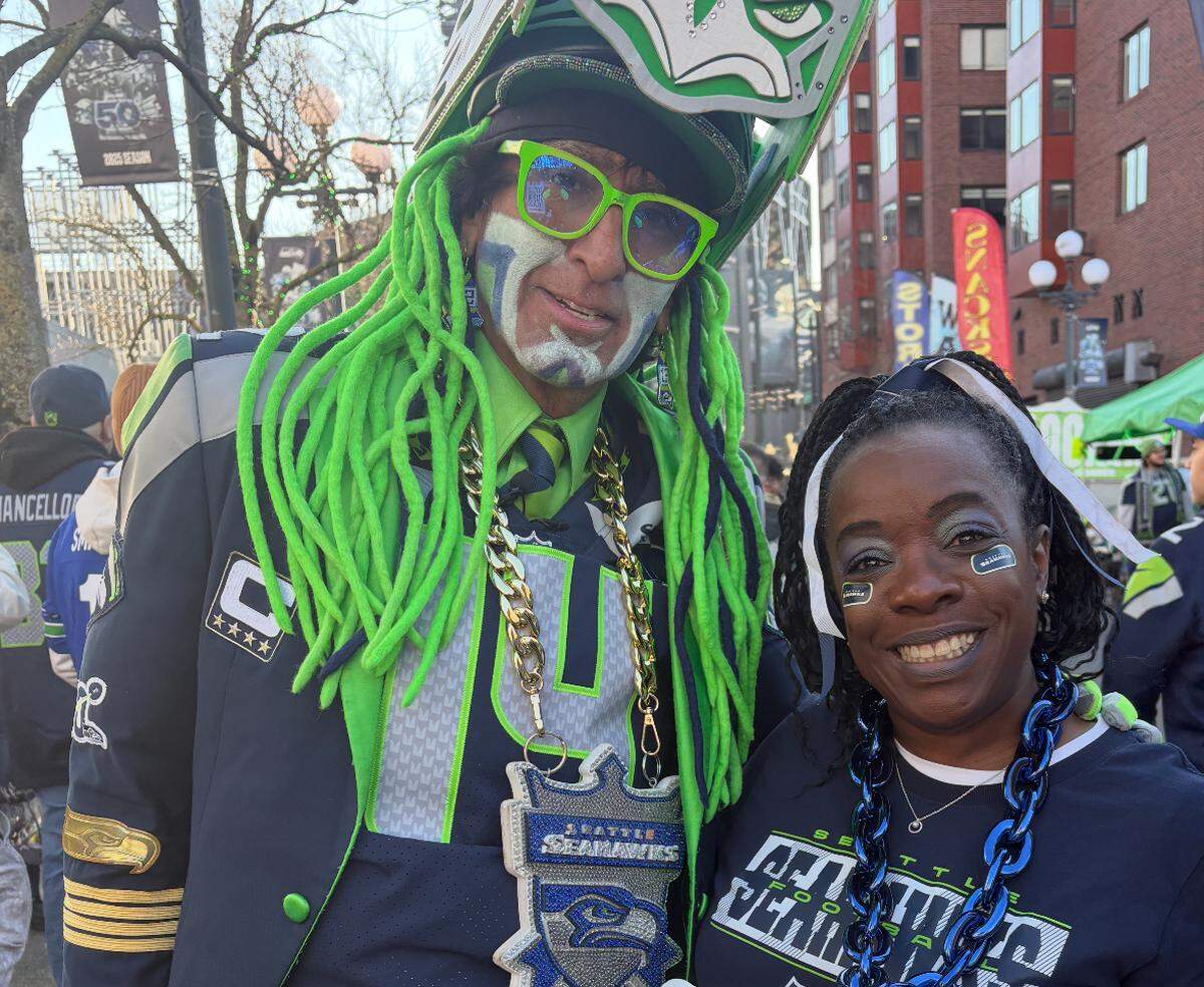Pamela Michelle Kinsey, a Richland resident and Seattle Seahawks superfan, poses with a fellow fan.