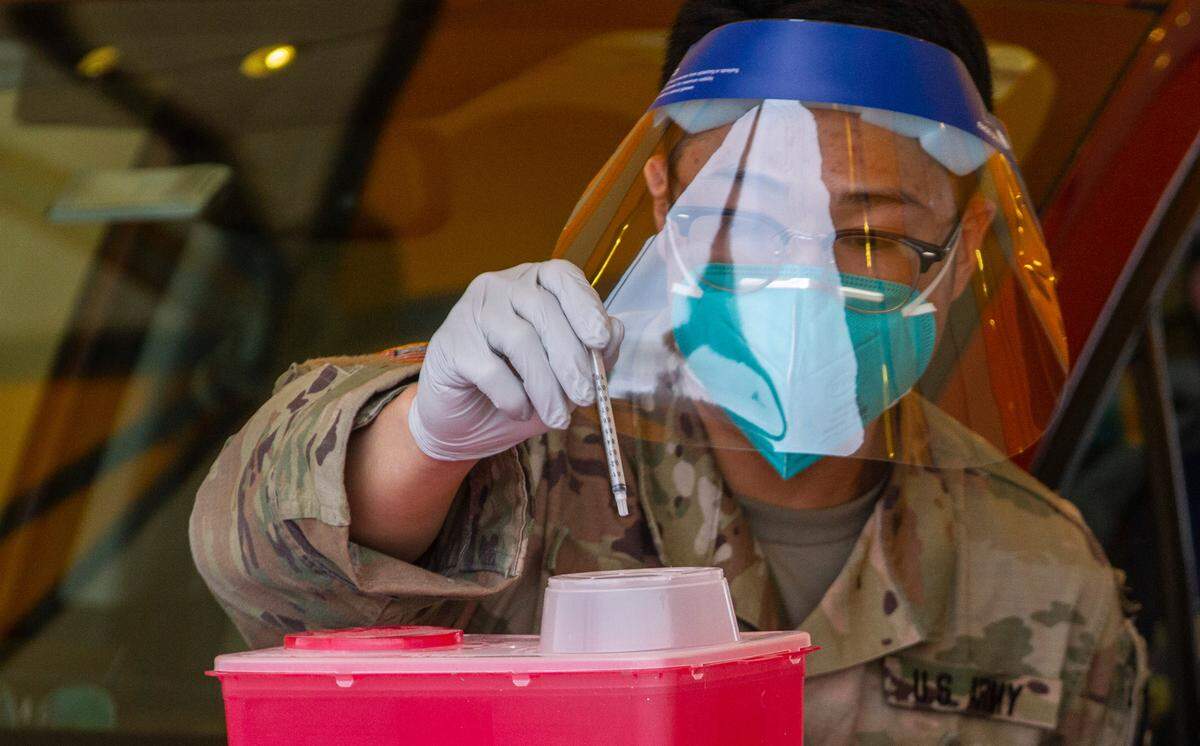 Sharps are safely discarded after use at the drive-thru COVID-19 vaccine site at the Benton County Fairgrounds.