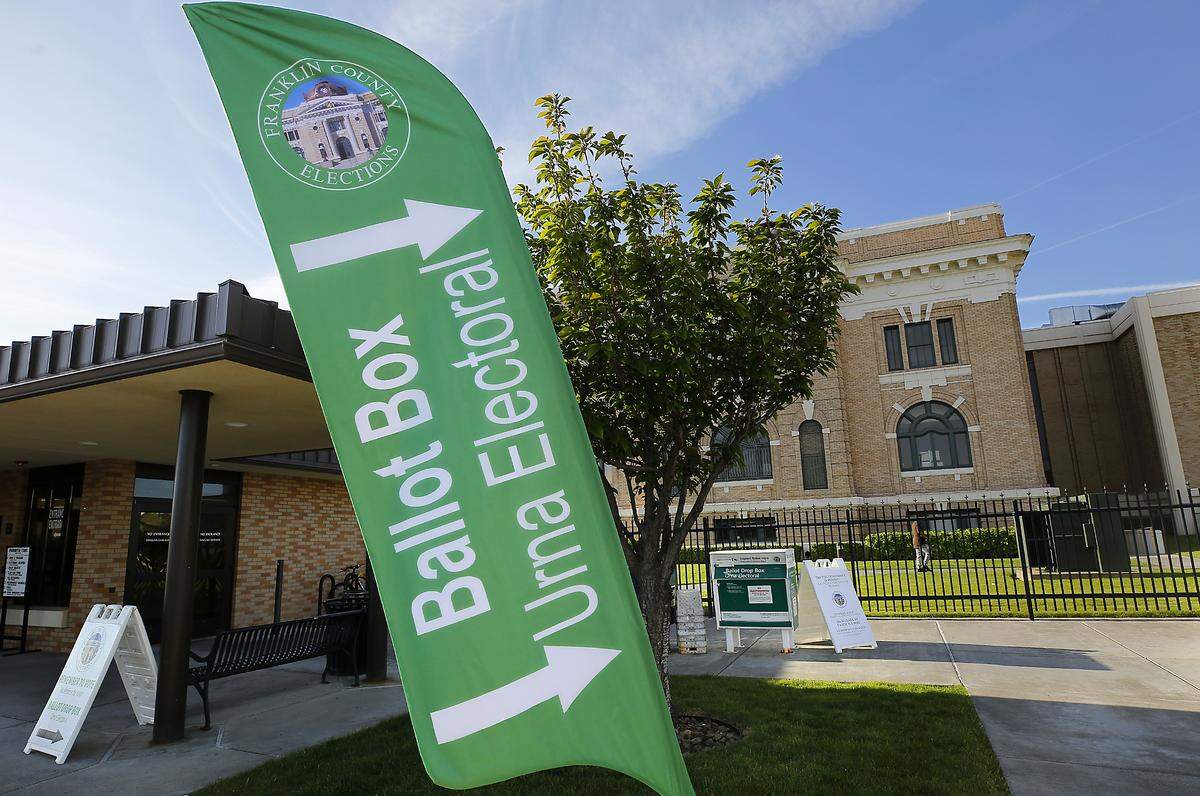 Signs point to the ballot drop box located just outside the security building at the Franklin County Courthouse in Pasco. 