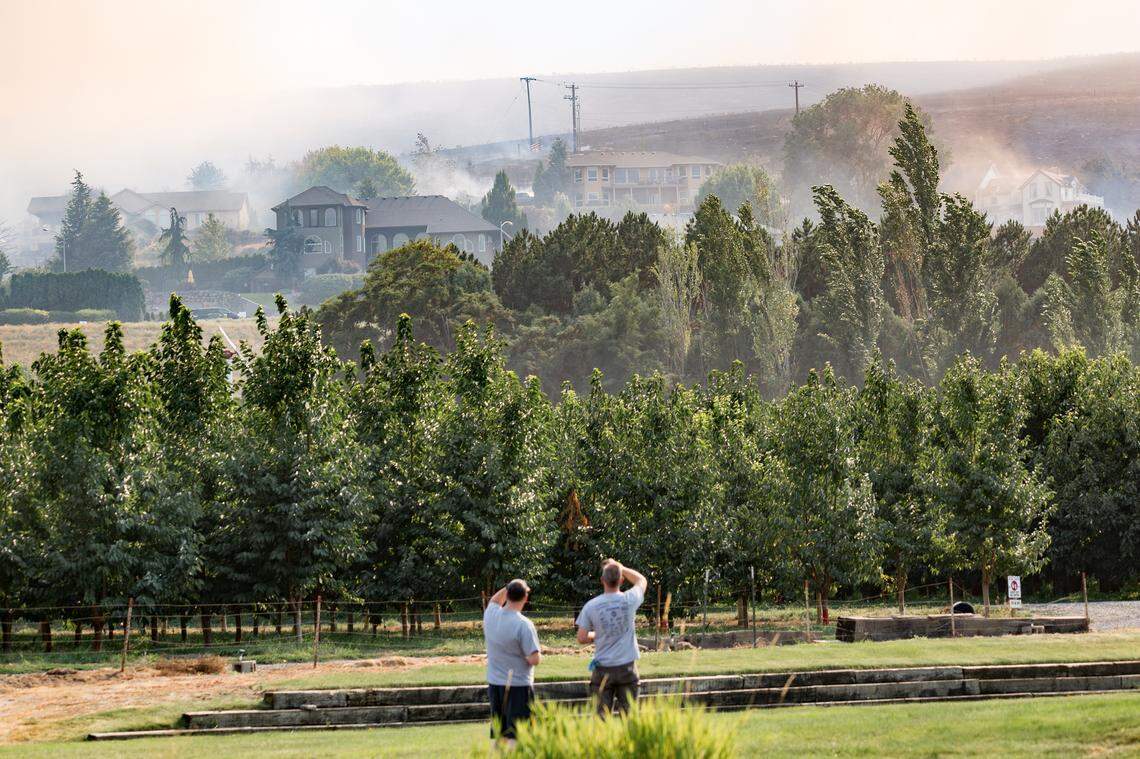 Firefighters worked through the night to stall the Bofer Canyon fire after it destroyed five homes in South Kennewick and threatened parts of Finley on Saturday.