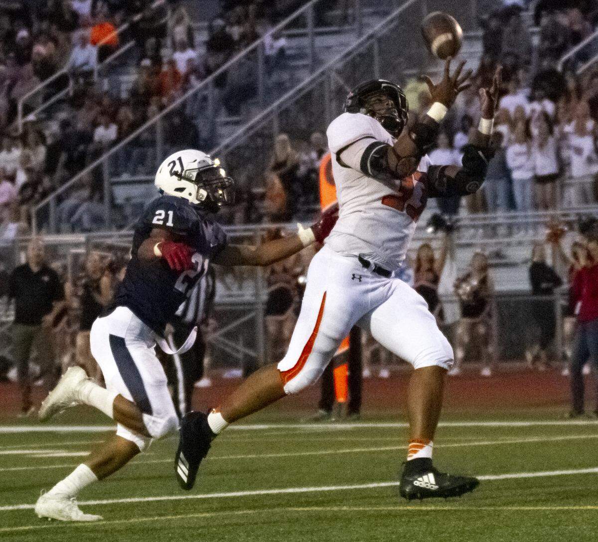 Chiawana’s Aarloh Valdovinos (21) attempts to tackle Kennewick’s Jagger Childs (33) as he goes for the ball during a Mid-Columbia Conference high school football game at Edgar Brown Stadium in Pasco on Friday. Chiawana won 37-0.