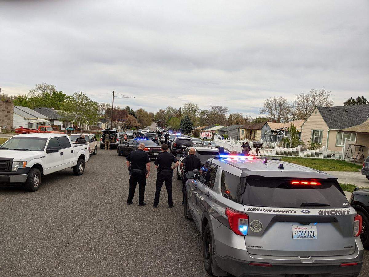 Kennewick police surrounded a home Wednesday night near the intersection of West Fifth Avenue and South Washington Street in connection with a fatally wounded man dropped off at an emergency room.