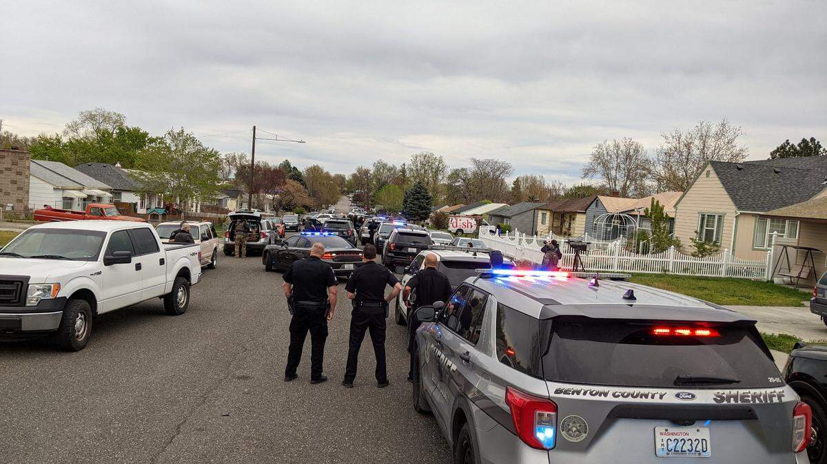 Kennewick police surrounded a home Wednesday night near the intersection of West Fifth Avenue and South Washington Street in connection with fatally wounded man dropped off at an emergency room.