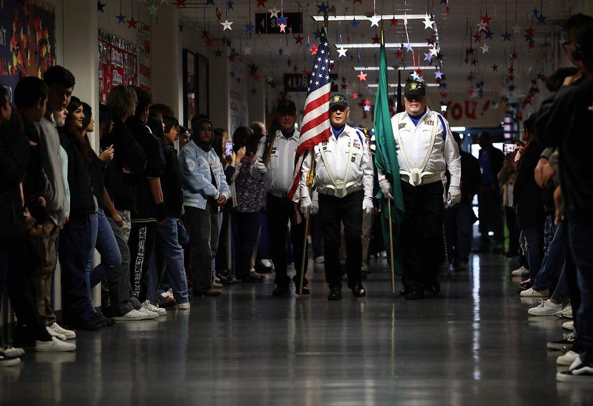 Members of the VFW Post 5785 presents the colors as Highland Middle School students line the main hallway of the Kennewick school as about local 80 military Veterans as they make their way to the gymnasium for the school’s Military Appreication Day ceremony. The National Junior Honor Society students, led by advisor Connie Fow, organized the celebration to honor those who have served the country. It was daylong event that included an assembly, luncheon and classroom visits by the Veterans. The keynote speaker at the assembly was retired submariner Capt. Ted Miller of Richland.