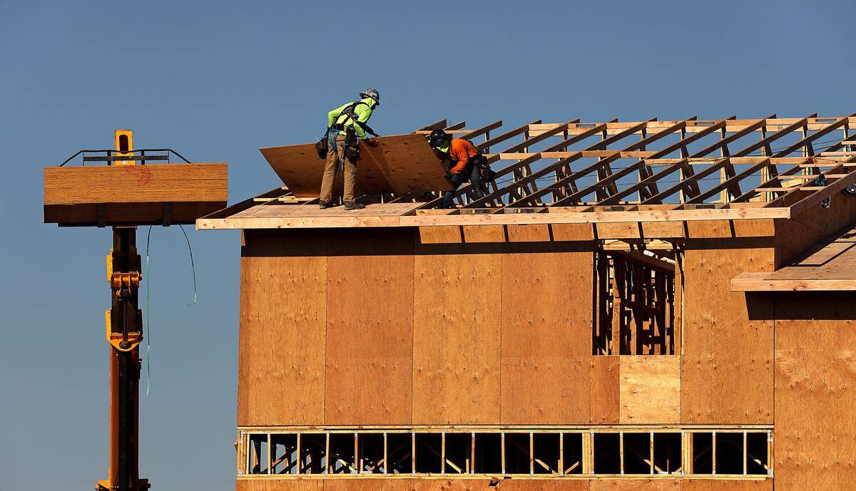 Covered for protection from the searing sun, construction workers place sheet of plywood for the roof of the newest phase of The Resort at Hansen Park. The National Weather Service reports Pasco set a new record high temperature of 109 degrees for Aug. 15. The development, located on a former orchard, includes homes, apartments and commercial development on the northwest side of that property in Kennewick off Columbia Center Boulevard and West 10th Avenue.