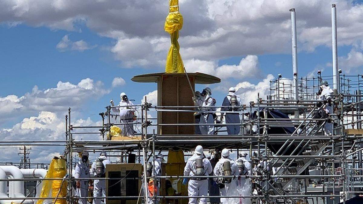 Hanford site workers remove old equipment from an underground waste tank. The Washington congressional delegation says more money is needed for Hanford cleanup.