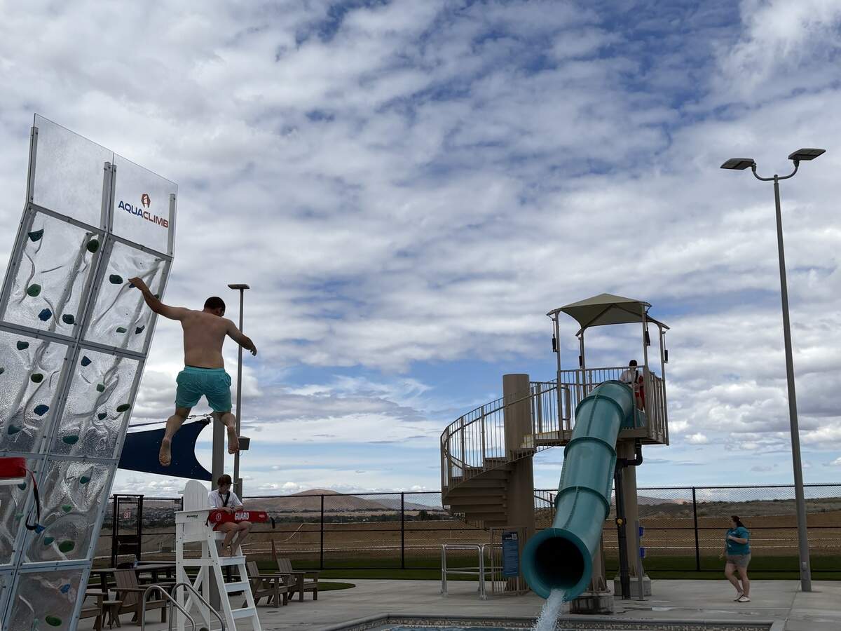 A visitor tries out the climbing wall at the Pasco Aquatic Center on Saturday, June 27.