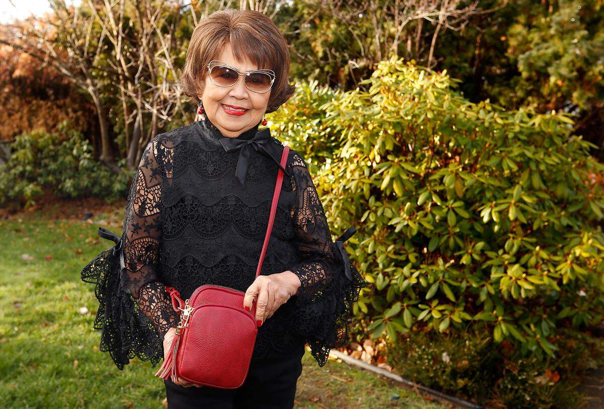 Josie Wannarachue, a longtime Tri-Cities businesswoman and civic leader, shows the purse named in her honor by her daughter, JoAnne Wannarachue Lord, the founder of a handbag company.