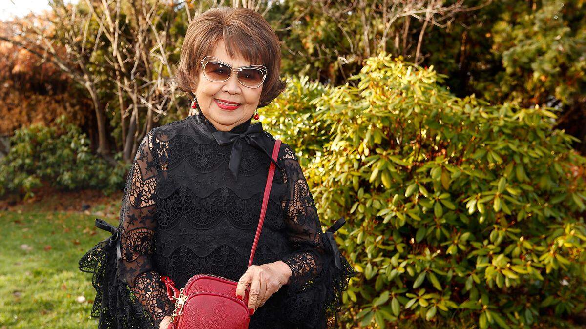 Josie Wannaruche, a longtime Tri-City business woman, show the purse named in her honor by her daughter, JoAnne.