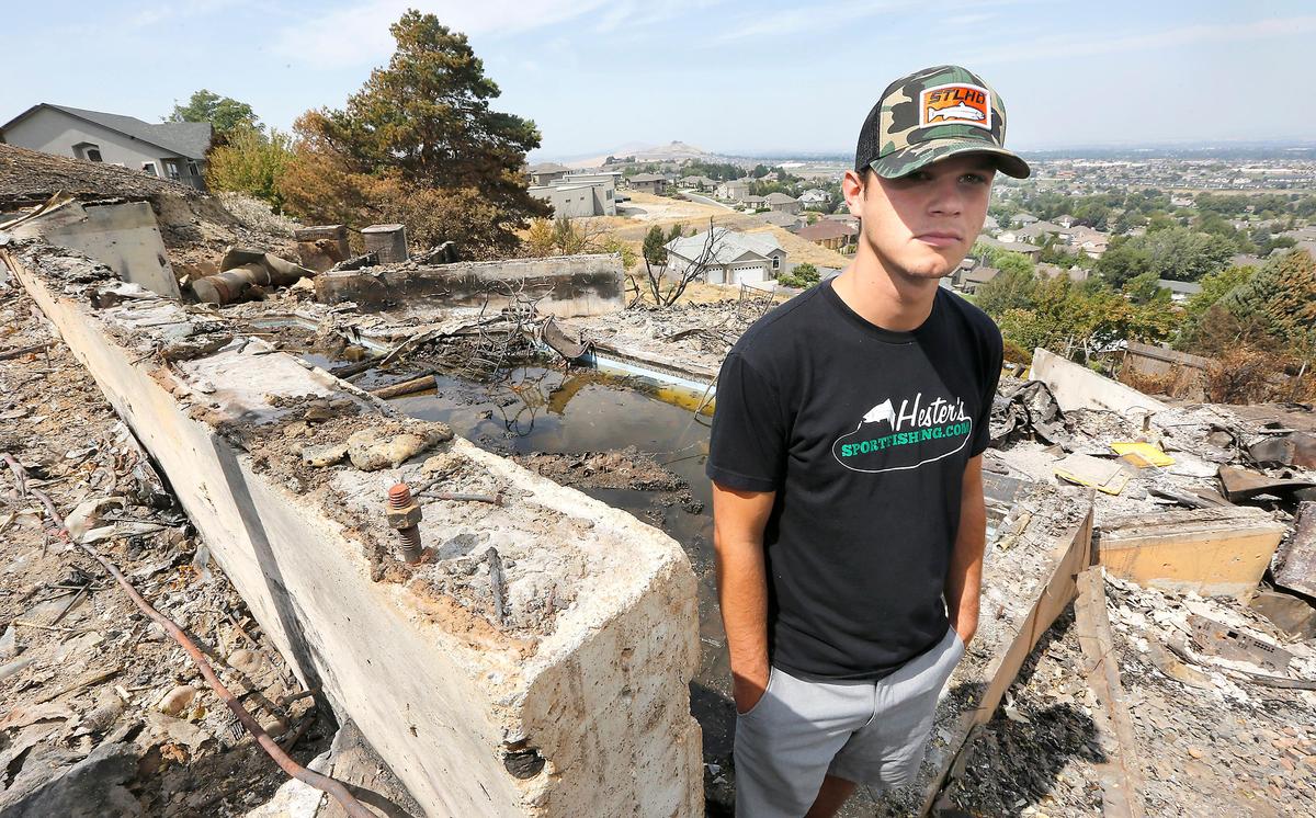 Tyler Miller stands near the concrete foundation of his parent’s house at 3403 W. 47th Ave. in Kennewick. Miller, a Benton County District 1 firefighter, got to the home in time to rescue family members and pets. Watch a video at: tricityherald.com/video