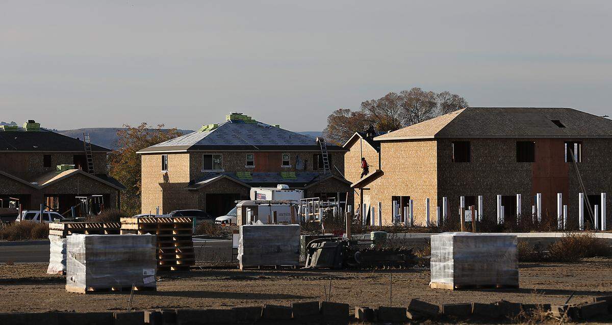 Construction worker build new homes in a new housing development on the southeast corner of the intersection of Road 68 and Argent Street in west Pasco.