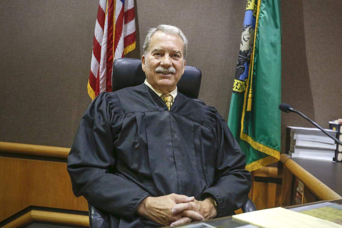 Judge Vic VanderSchoor poses for a photo in a Benton County Justice Center courtroom shortly before his retirement as a superior court judge in 2017.