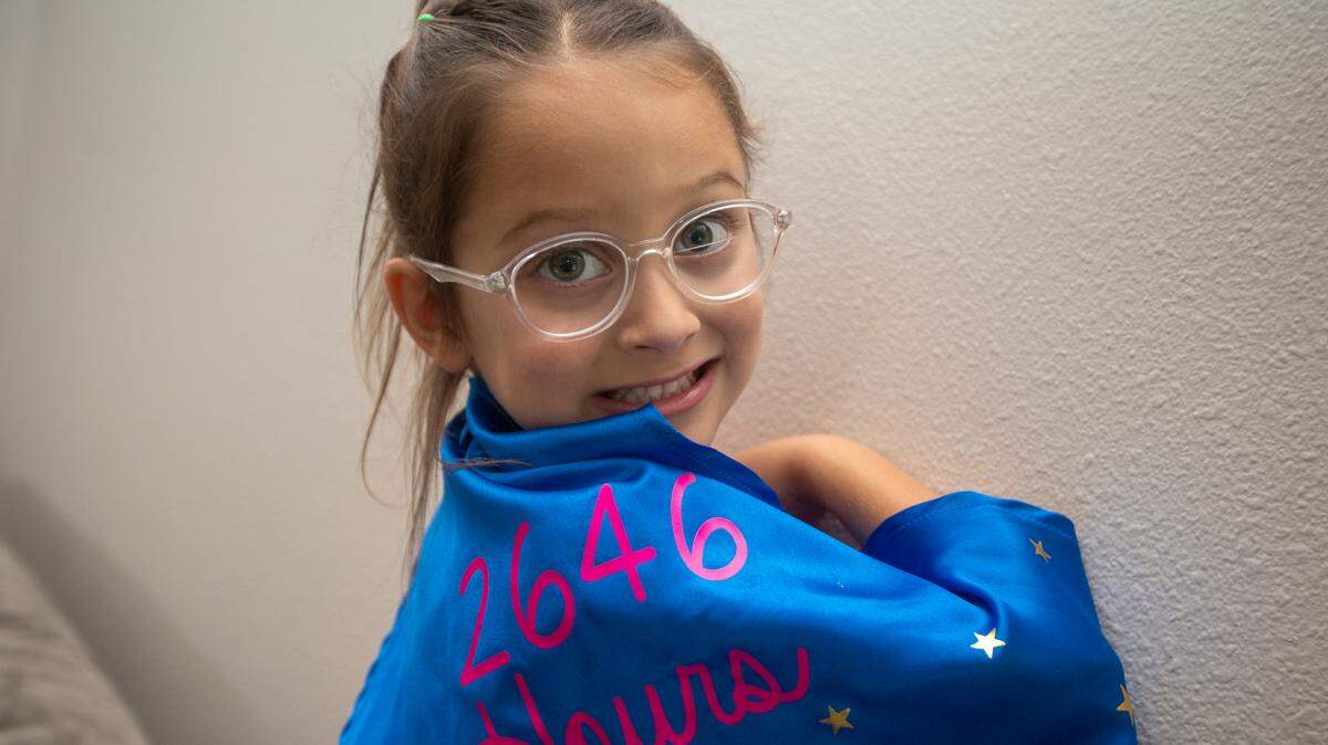 Aliyah Arambul shows off her cape with the numbers 2,646, representing the hours she had to wear an eye patch.