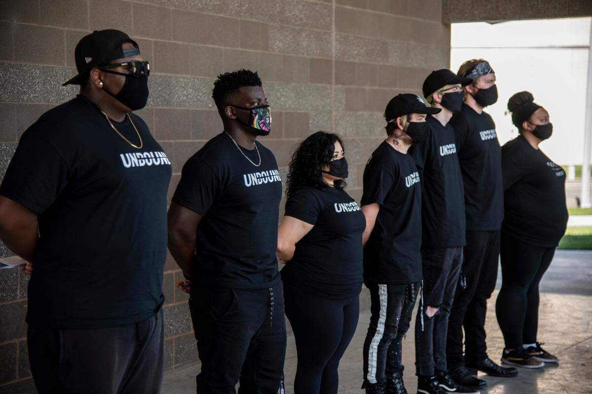 Members of Unbound, a community organization that has most recently focused on the Black Lives Matter movement in the Tri-Cities, stand in solidarity as the director of operations, Antha Hansen (not pictured), reads a list of demands that the organization has for local police.