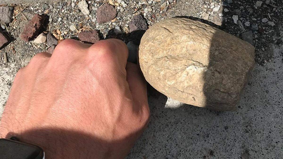 A 37-year-old man is accused of threatening a Kennewick police officer with a large rock Sunday afternoon.