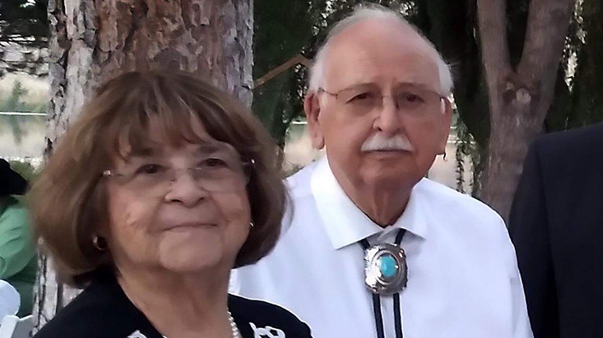 Lillian and Ernesto Parra pose at a family gathering before their home was destroyed by arson.