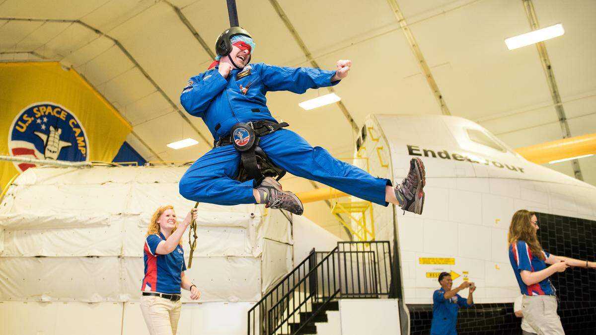 Richland teacher Trevor Macduff flies in the 1/6th gravity chair at Honeywell Educators at Space Academy at the U.S. Space and Rocket Center in Huntsville, Ala. on June 24, 2018.