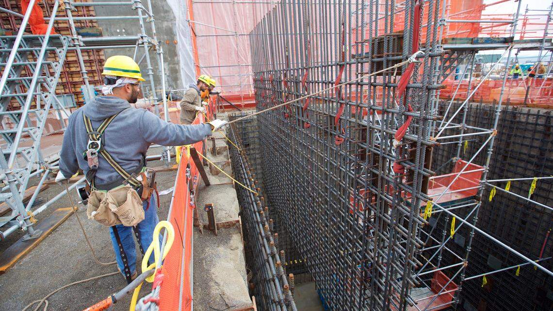 Employees lower a rebar curtain into place at the Effluent Management Facility at the Hanford vitrification plant.