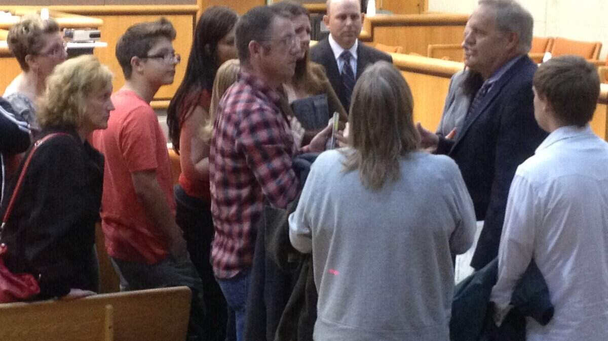 Benton County Prosecutor Andy Miller talks with Joshua Snapp's family Friday after John Young of Richland was found guilty of killing Snapp last summer. A jury convicted Young of first-degree murder.