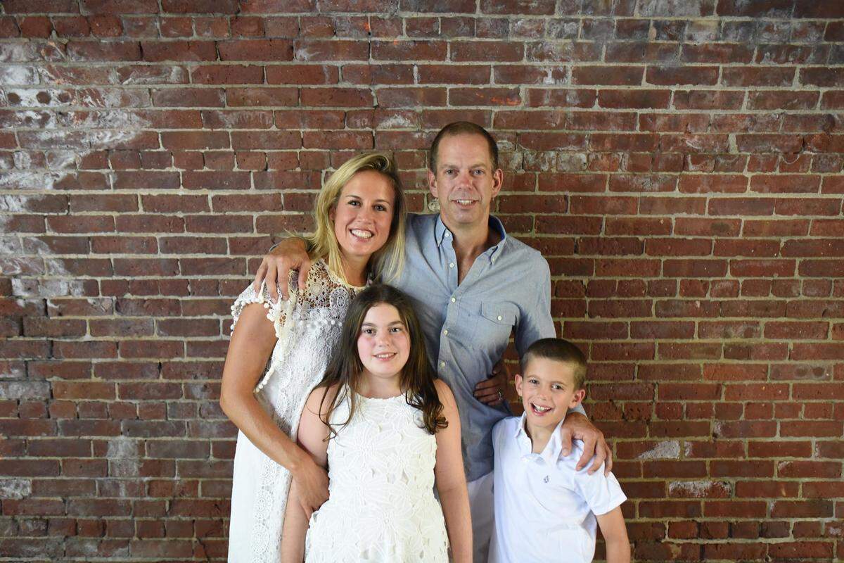 Emily Faurholt-Sann (back row left) with her husband Jim Sann and children Avery and Teddy.