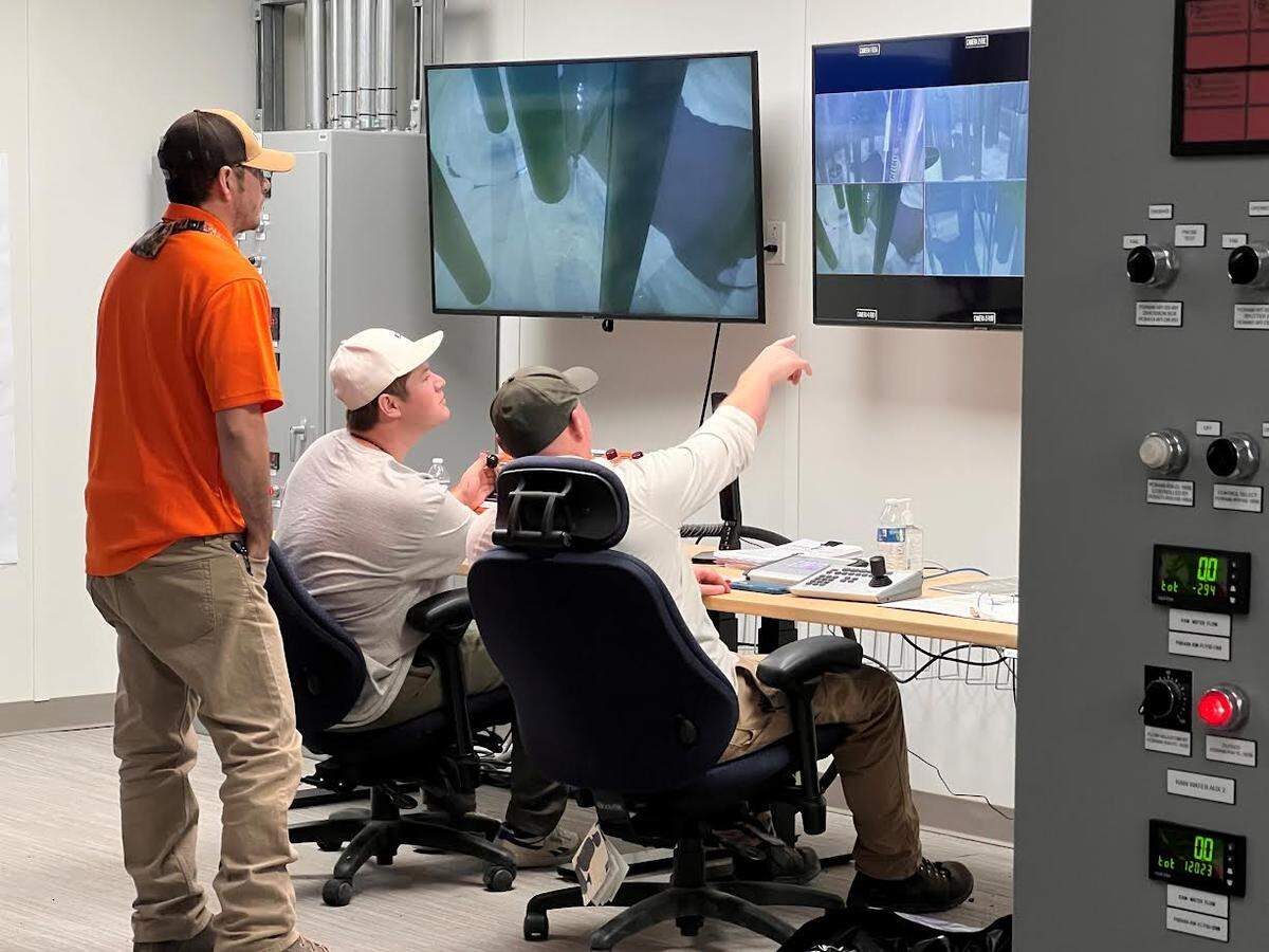 Workers use remote-operated equipment to mobilize radioactive waste and direct it toward a pump for transfer to a double-shell tank for eventual treatment for permanent disposal.