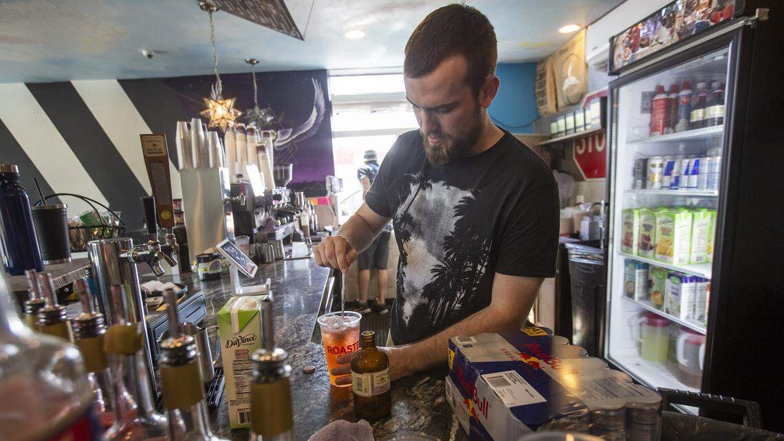 Barista Blake Clatterbuck makes a beverage inside of Roasters Coffee in Kennewick. The Tri-Cities economy is adding jobs and workers, but it's also increasing its average hourly wage to the point that it's second only to Seattle.