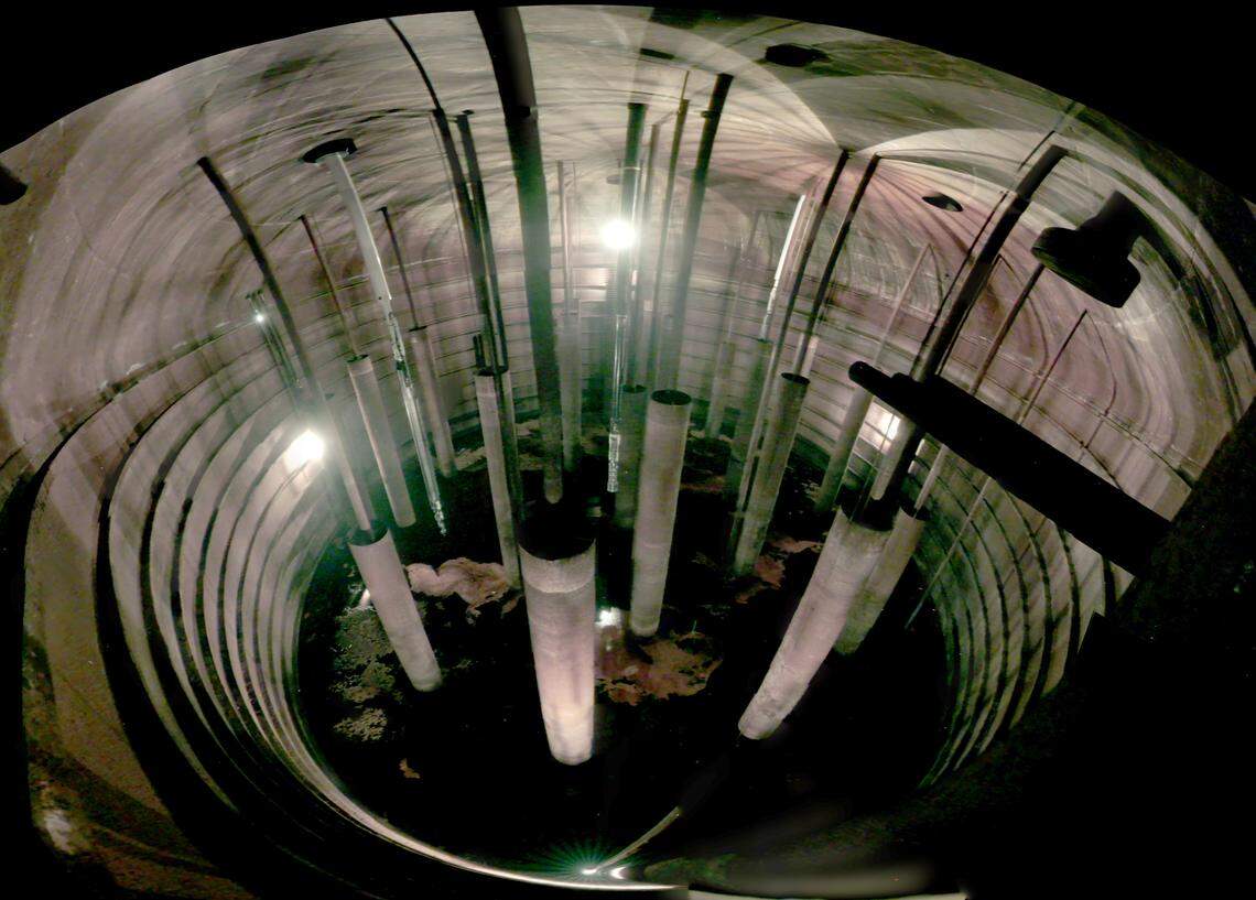 The interior of Tank AX-102 is shown. Most the pipes were used for mixing, and the sluicer that will be used to empty the waste from the tank is the white object extending into the tank on the left.