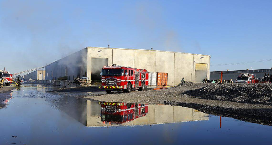 Firefighters work to extinguish an early morning warehouse fire in the Port of Pasco's Big Pasco Industrial Center.