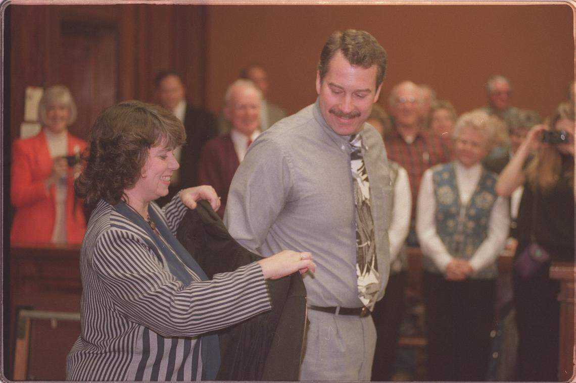 Vic VanderSchoor puts on his judge's robe for the first time with the help of his wife, Gail, as he was sworn in to the Benton Franklin County Superior Court in January 1997.