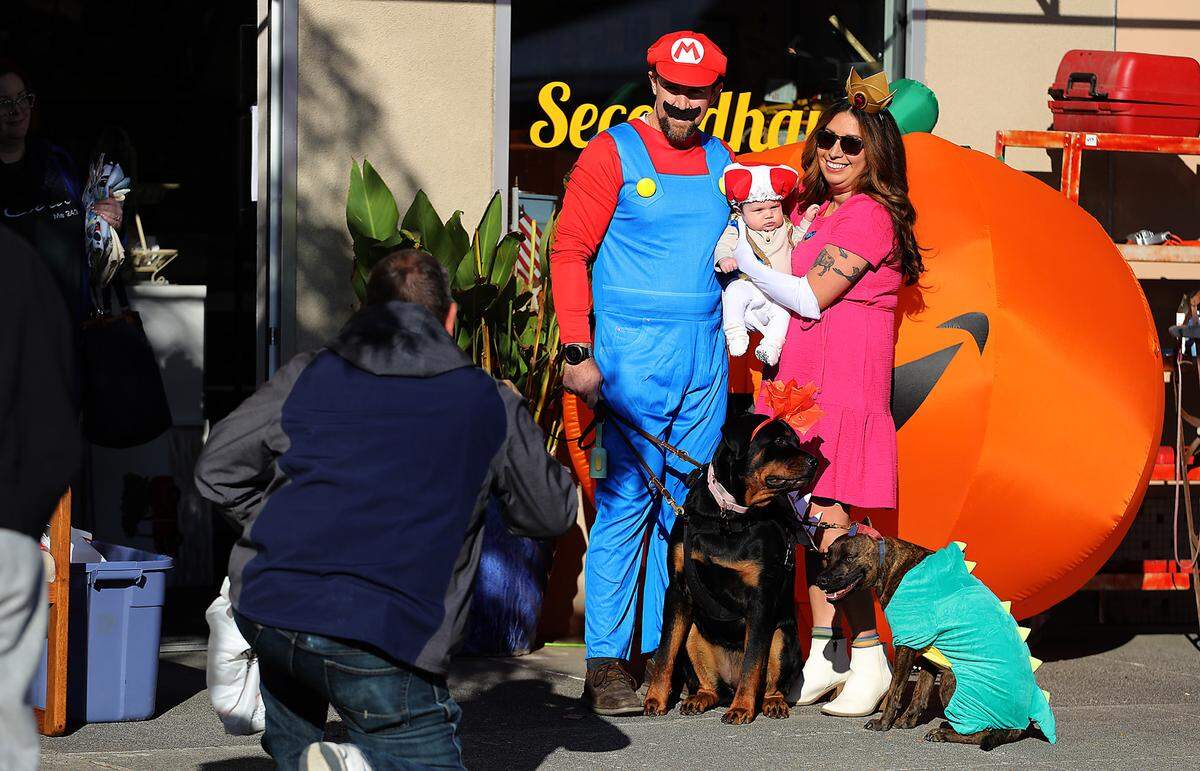 Selena Ruiz and Evan Howard pose for a Halloween picture with their daughter Aurelia Howard-Ruiz, 2 months, and family pets Bruin and Rocky during the Downtown Kennewick Halloween Boo Bash. Hundreds roamed the blocked off downtown Kennewick streets for the event in 2023.