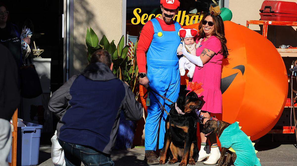Selena Ruiz and Evan Howard pose for a Halloween picture with their daughter Aurelia Howard-Ruiz, 2 months, and family pets Bruin and Rocky during the Downtown Kennewick Halloween Boo Bash. Hundreds roamed the blocked off downtown Kennewick streets for the event.