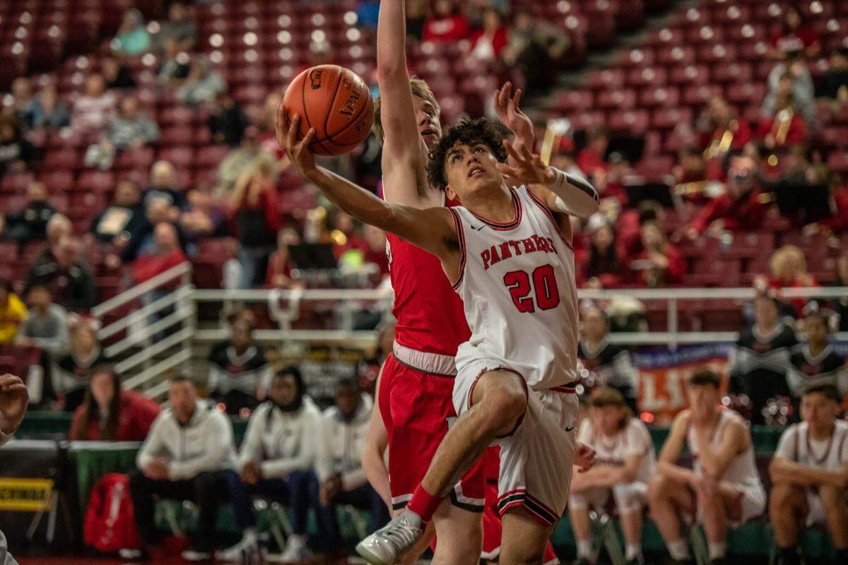 Braulio Mendoza, a six foot junior for River View, goes in for a basket against a King’s Knights defender during Tuesday’s 1A playoff game