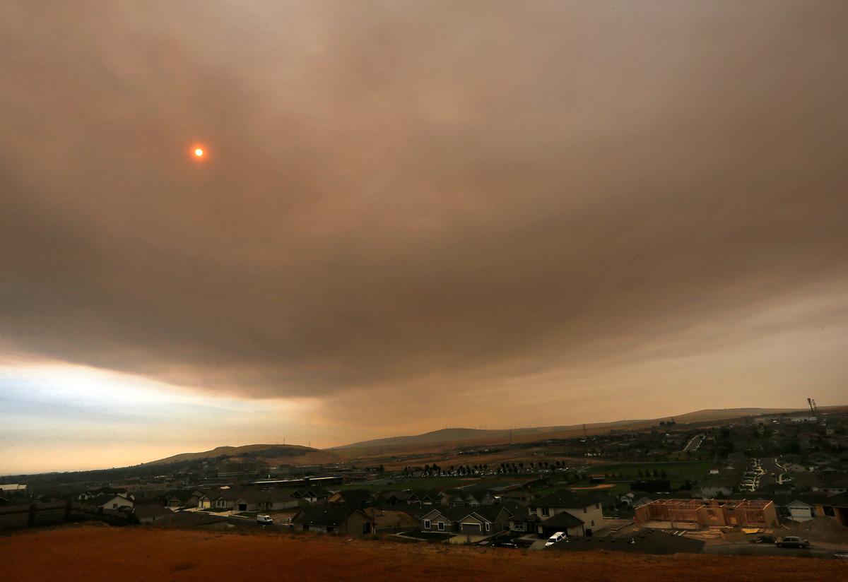 Smoke pouring into the Tri-Cities area Friday morning from a wilderness fire obscures the sun and creates a yellowish haze in the sky.