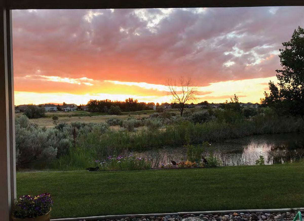 Sunset as seen through the window of a home on Crosswater Loop in Horn Rapids.