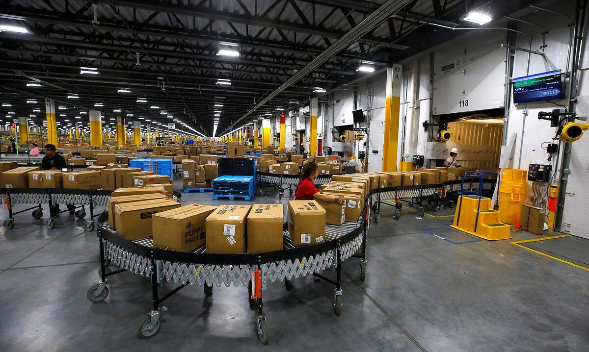 Employees prepare boxes for loading into trailers and transport to regional fulfillment centers in the Amazon network from Amazon’s package hub in east Pasco.