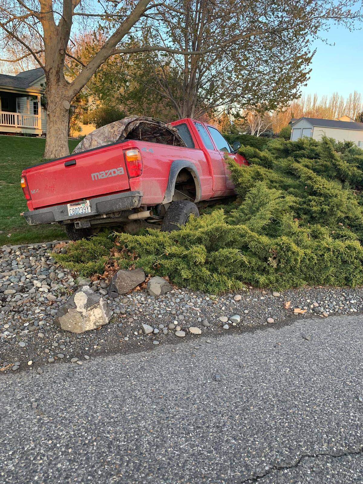 A road rage incident in West Richland ended with a pickup crashed into bushes in front of a house on East Lake Court.