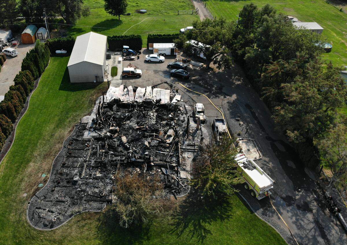 Investigators work at one of two fire scenes along East Finley Road just east of South Locust Lane that were part of Wednesday morning’s violent and fiery rampage across the Tri-Cities. Two people were reported shot and a third escaped to safety after a suspect opened fire and then lit the house ablaze. The 43-year-old suspect died in his burning pickup truck during a shootout with police on Van Giesen Street.