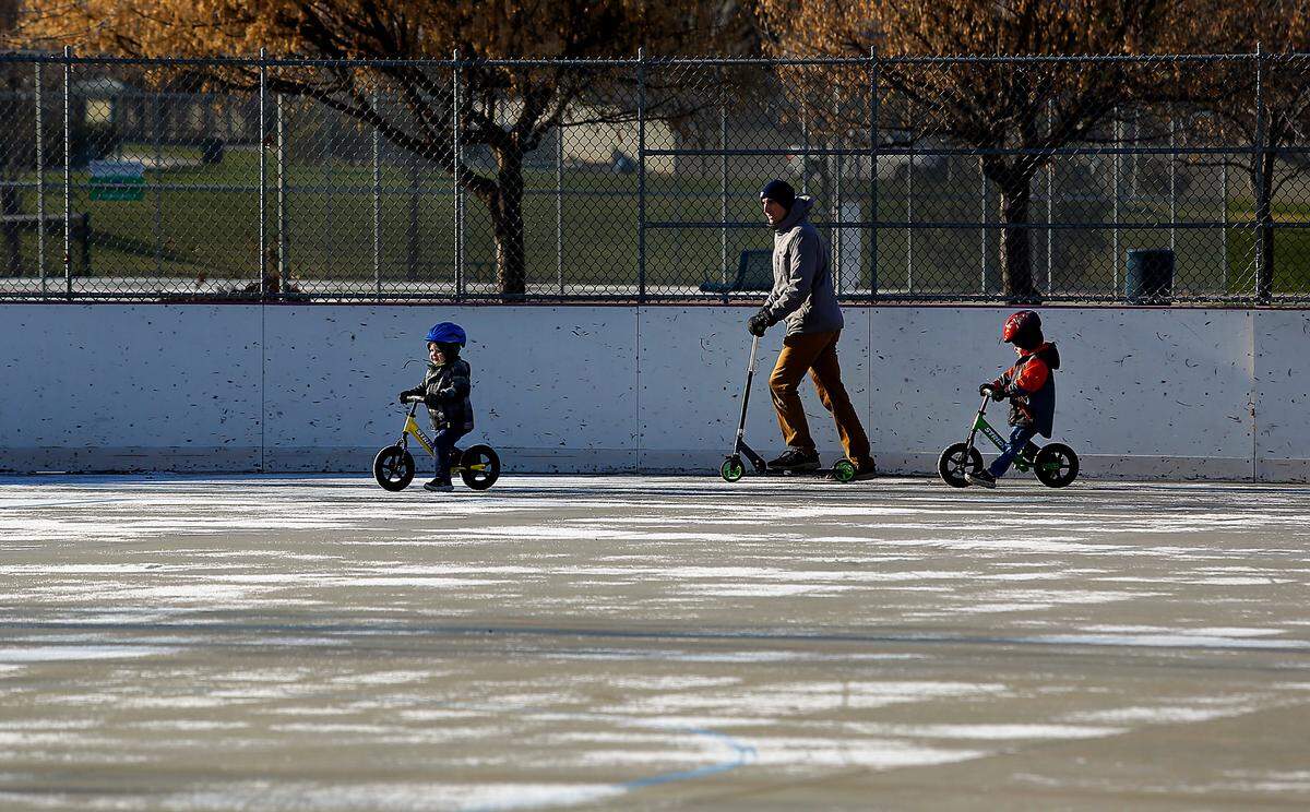 Brice Hunter and his sons, Easton, 2, and Owen, 4, at right, bundle up against frigid temperatures despite bright sunshine during a family outing to Highlands Grange Park on South Union Street. The Kennewick family, including Brice’s wife and two other children, were spending time outdoors playing and trying new Christmas toys before even colder temperatures arrive across the Mid-Columbia.