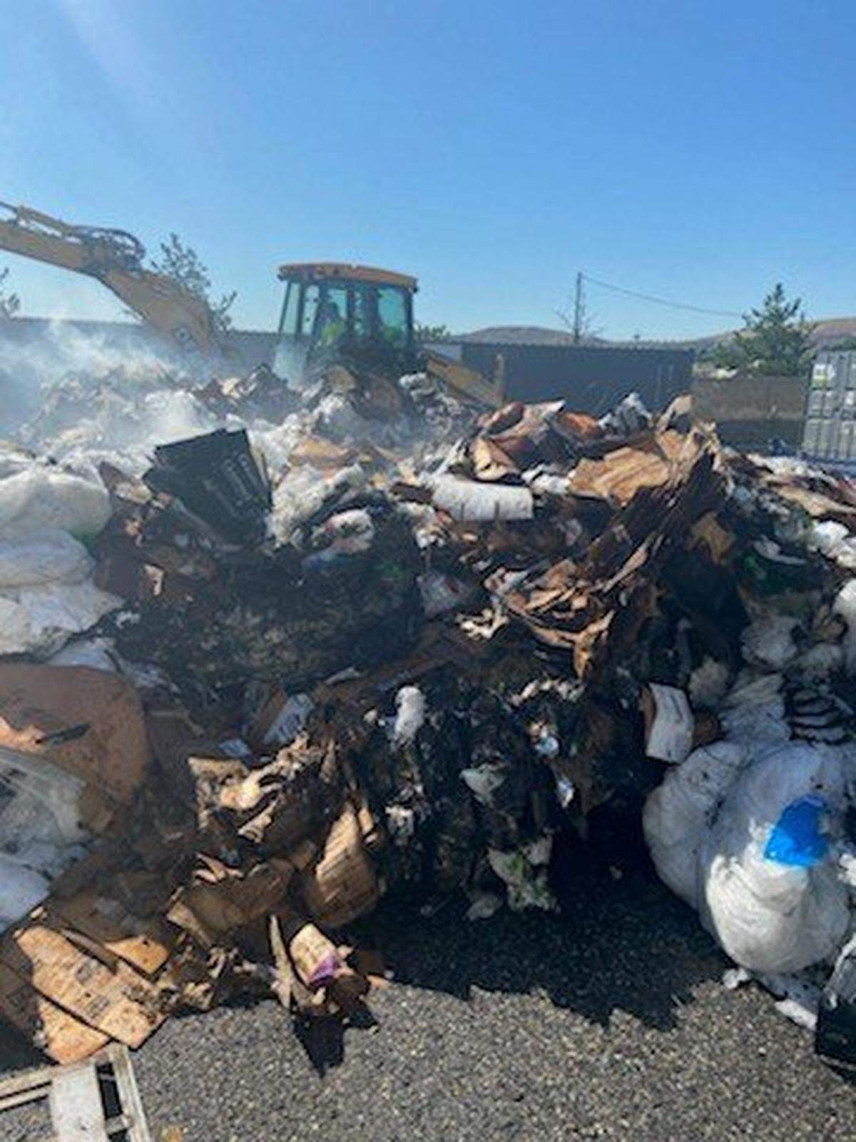 A cardboard receptacle behind Richland’s Walmart on Duportail Street caught on fire Monday morning.