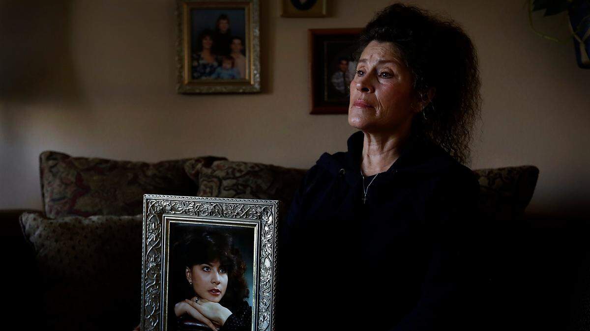 Kathy Shirey of Kennewick holds the framed 1980 Hanford High graduation portrait of her sister Linda Ramos-Moore whose body was recently discovered after she went missing in the Seattle area in November 1990.